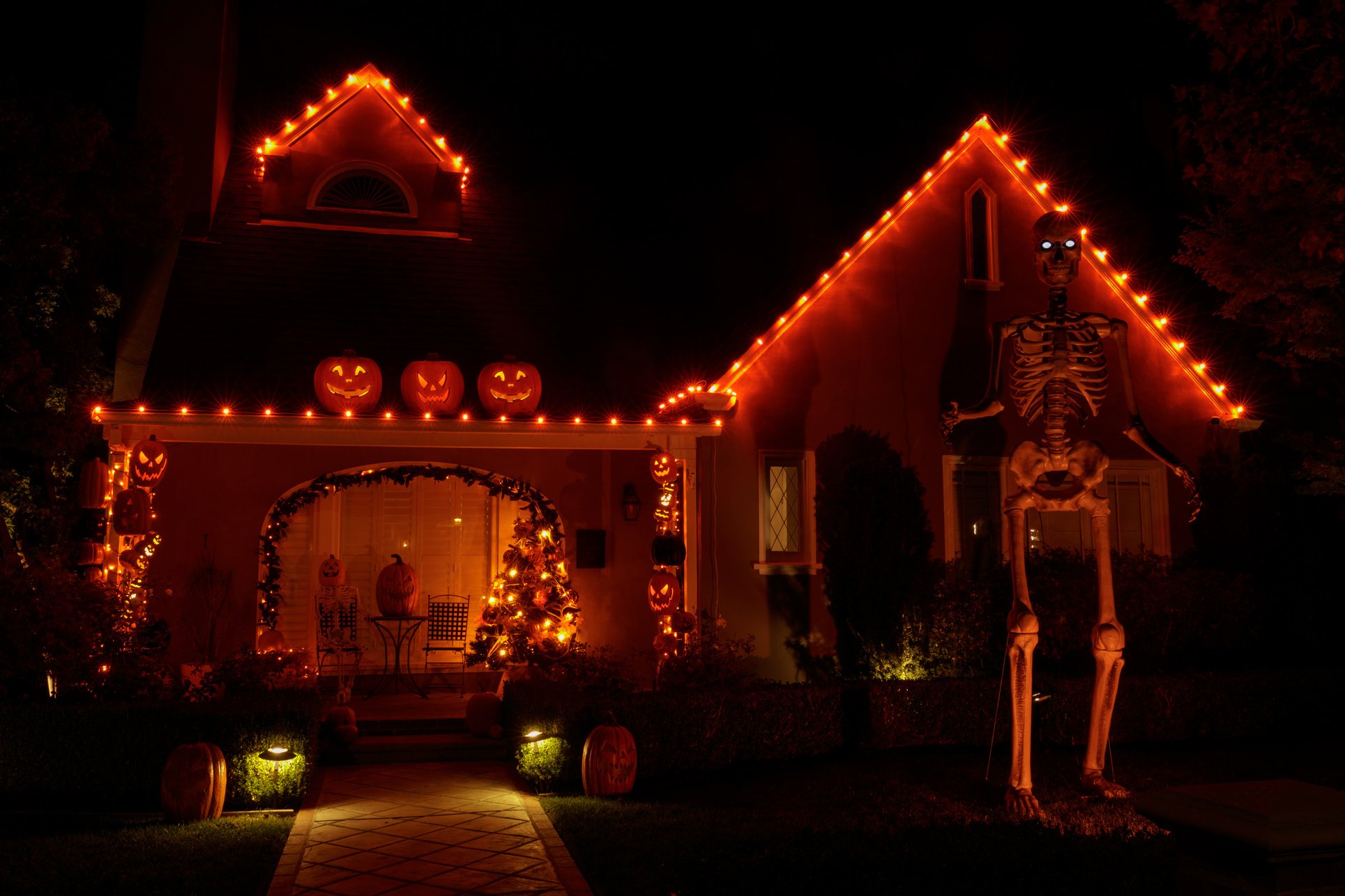 Halloween Jack-o-lanterns and Skeleton Decorating House at Night